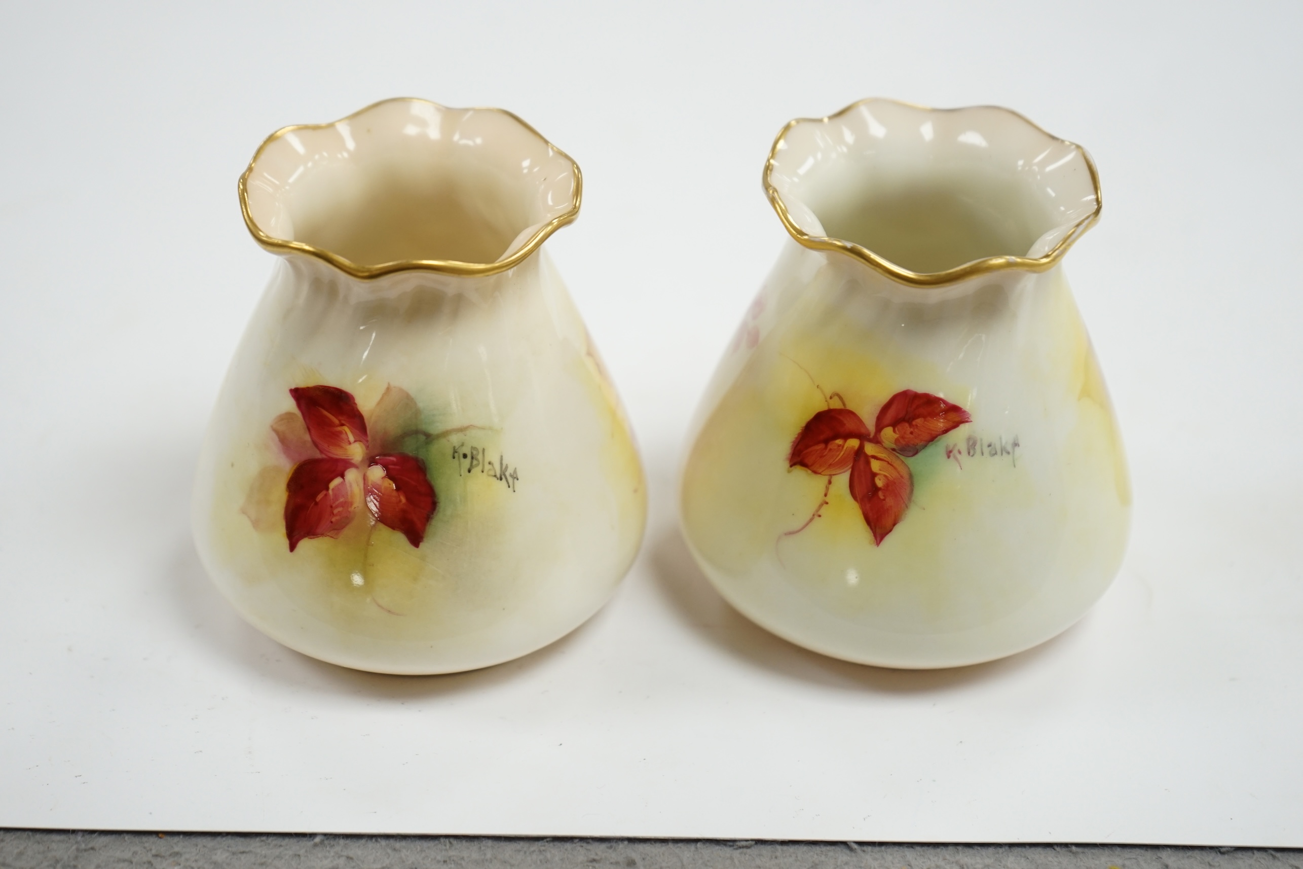 A pair of Worcester K. Blake pots, 8cm high. Condition - some gilding missing